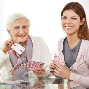 A woman and an older lady holding cards.