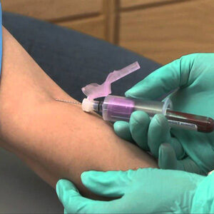 A person getting an injection in their arm.